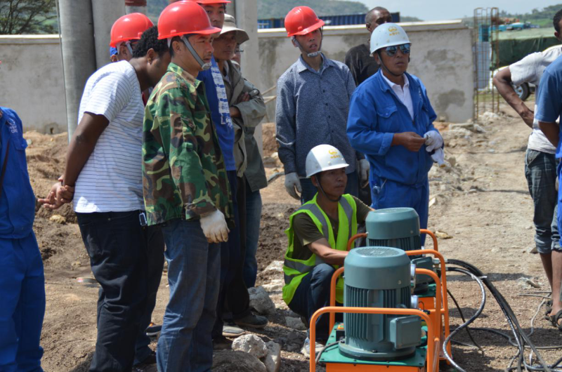 The deputy manager (Yang Daxiang, the man who is operating jack to install main transformer) in substation discipline, and his team. Source: http://www.crecg.com/english/2745/2808/10068432/index.html