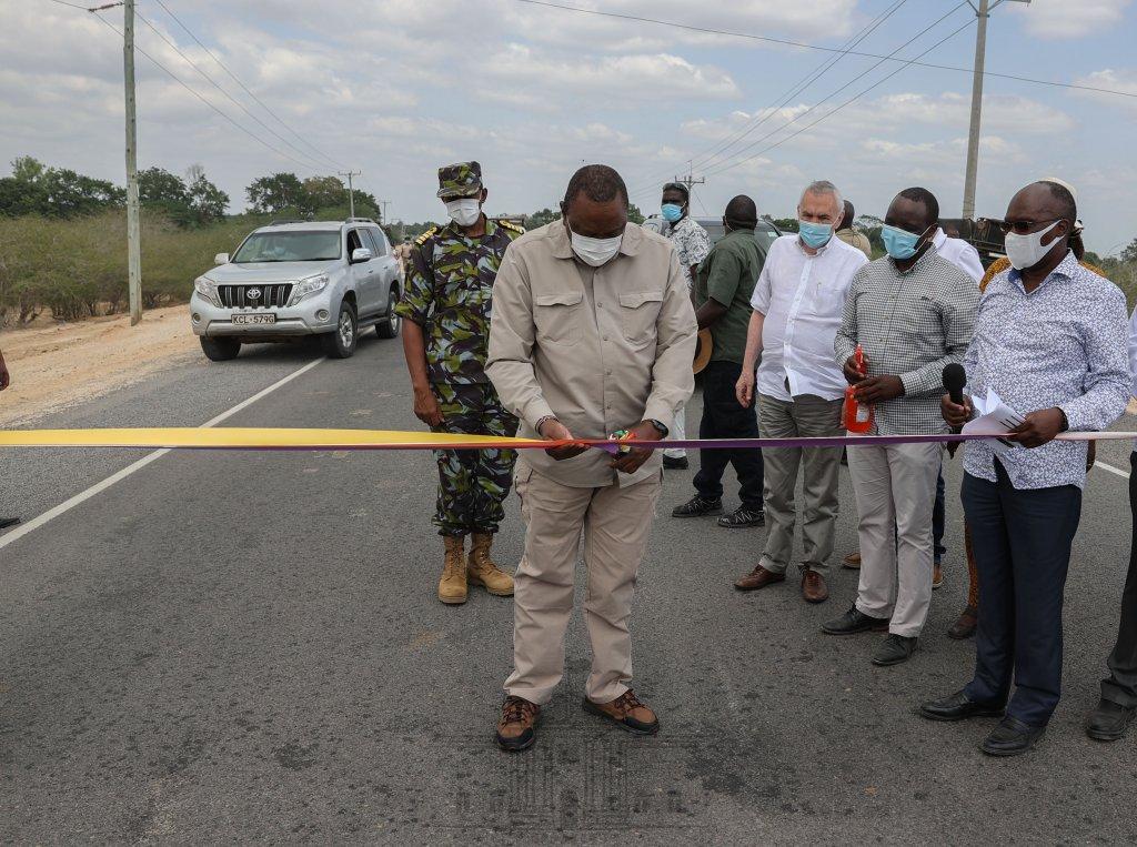 President Uhuru Kenyatta arrives at Minjila in Garsen, Tana River County, to officially open the 114km Garsen-Witu-Lamu road on his way to Lamu County to preside over the operationalization of the first berth of the new Lamu Port, May 20, 2021. Source: https://africa.cgtn.com/2021/05/20/president-uhuru-kenyatta-commissions-kenyas-lamu-port/