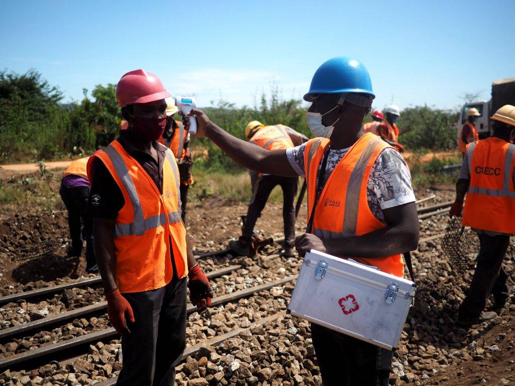 A community health worker takes temperature for his colleague at a site of Tanzania's Central Railway Line rehabilitation project undertaken by China Civil Engineering Construction Corporation in Tanzania on May 30, 2020. Source: https://www.sohu.com/a/413000663_267106