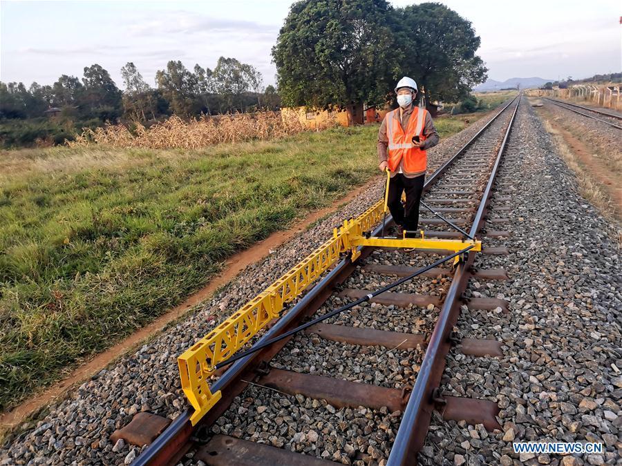 Assistant engineer Zhang Guikai measures tracks at a site of Tanzania's Central Railway Line rehabilitation project undertaken by China Civil Engineering Construction Corporation in Tanzania on Aug. 5, 2020. Source: http://www.xinhuanet.com/english/africa/2020-08/14/c_139290023.htm