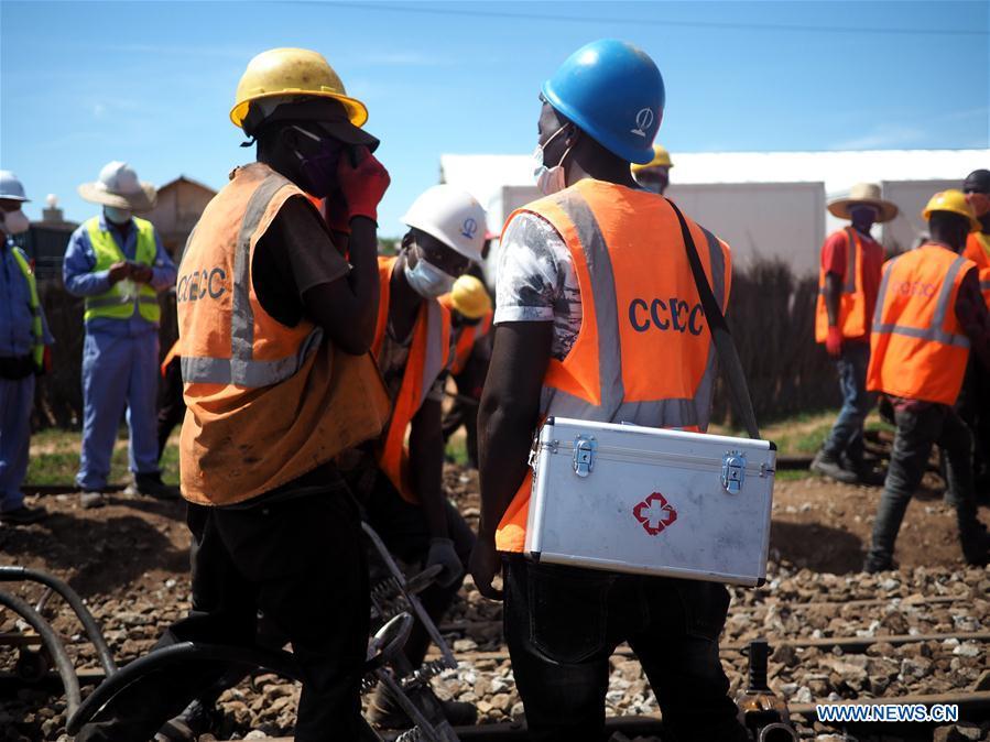 A community health worker (R, front) shares COVID-19 safety knowledge with colleagues at a site of Tanzania's Central Railway Line rehabilitation project undertaken by China Civil Engineering Construction Corporation in Tanzania on May 30, 2020. Source: http://www.xinhuanet.com/english/africa/2020-08/14/c_139290023_4.htm