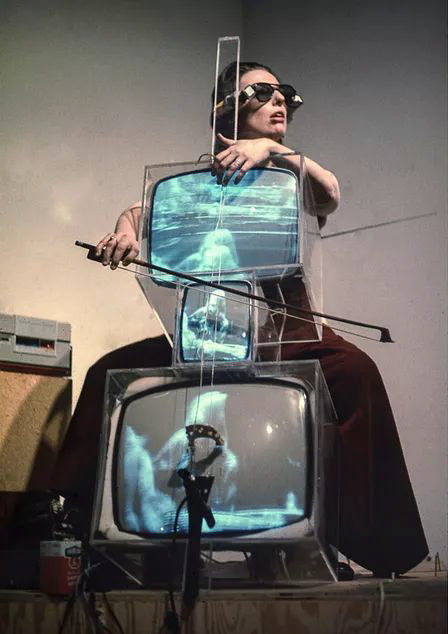  Charlotte Moorman performing on Nam June Paik’s TV Cello wearing TV Glasses, Bonino GAllery, New York City, 1971. Photo: Takahiko Iimura. © Takahiko Iimura. Courtesy of Grey Art Gallery, New York University;